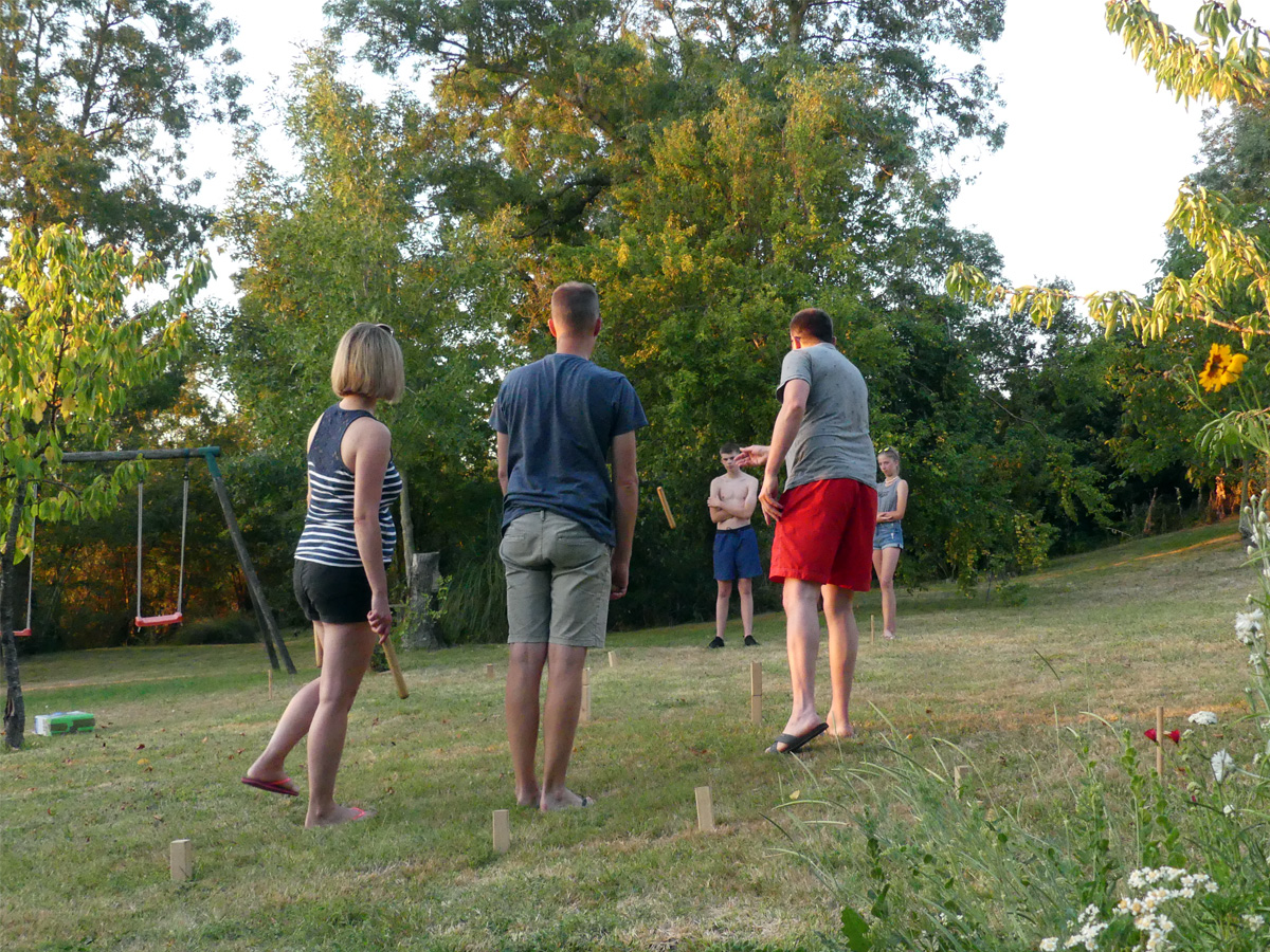 Playing Kubb at Maison Lairoux Holiday Homes