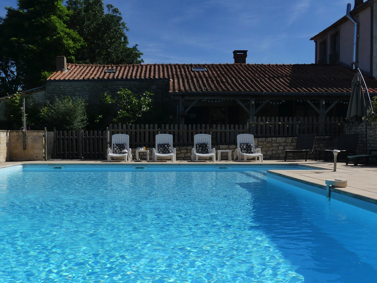 Relax by the pool at L Ecurie Holiday Home