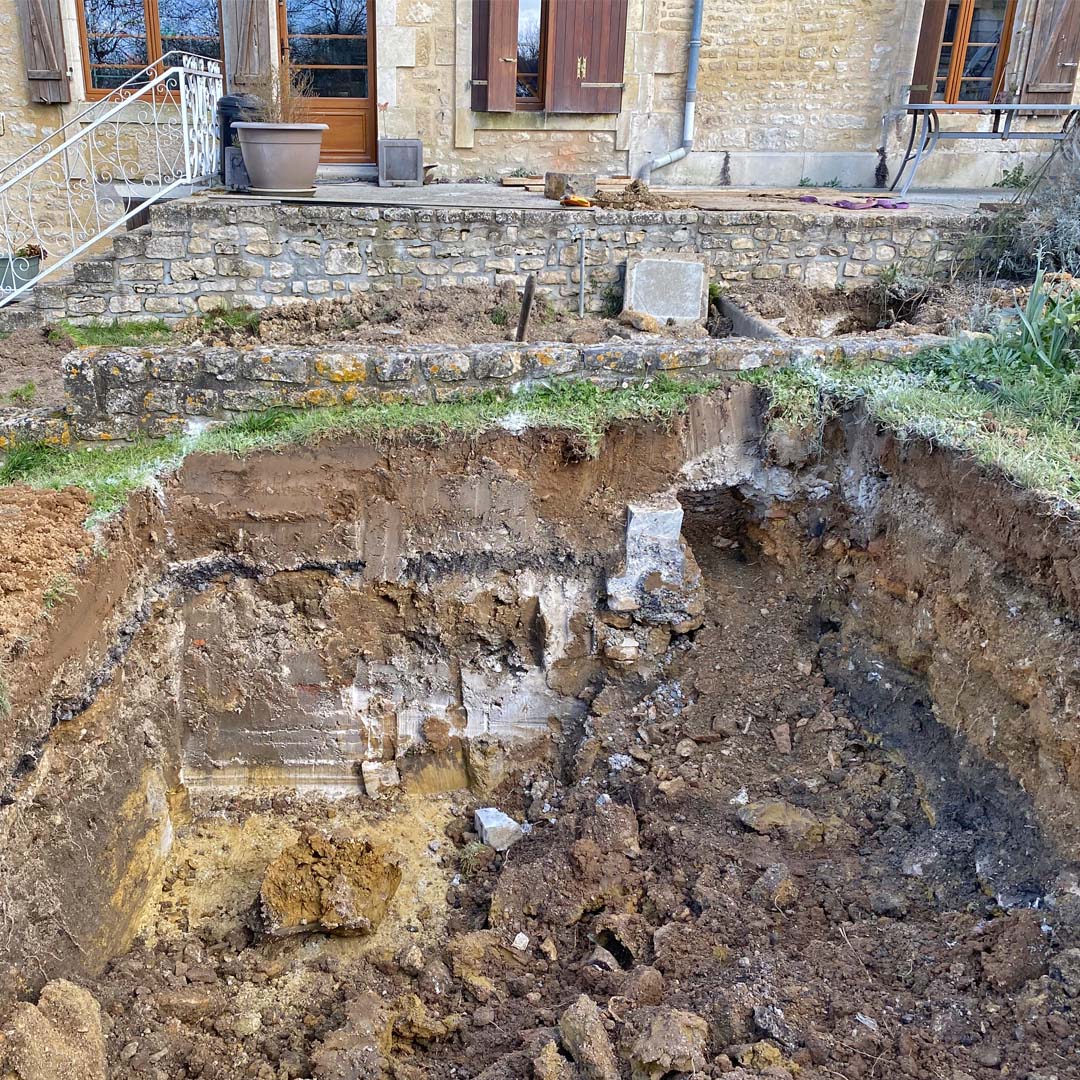 Digging out the soil for the new septic tank